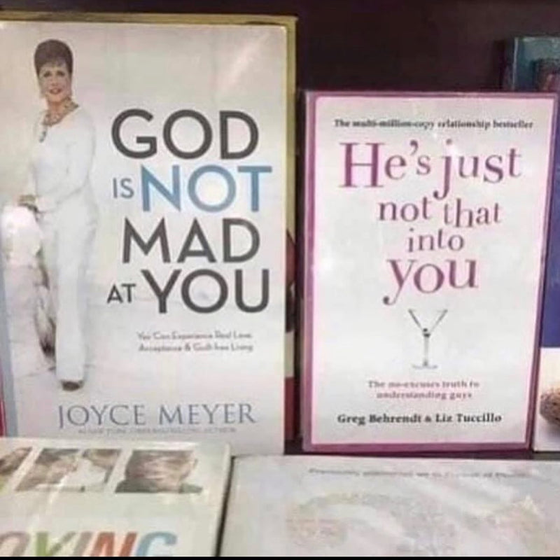 Two books side by side on a shelf: Joyce Meyer's God Is Not Mad at You next to He's Just Not That Into You, so the titles read together.