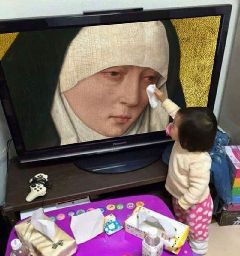 A toddler with a pacifier reaches up with a tissue to wipe the tears of a weeping Virgin Mary in a medieval painting shown on a TV screen.